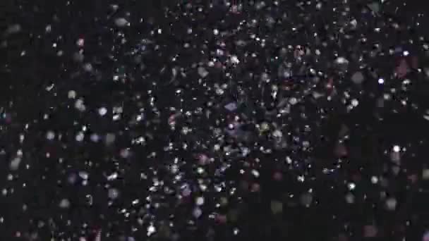 Glitter realista que explota en el fondo negro . — Vídeo de stock