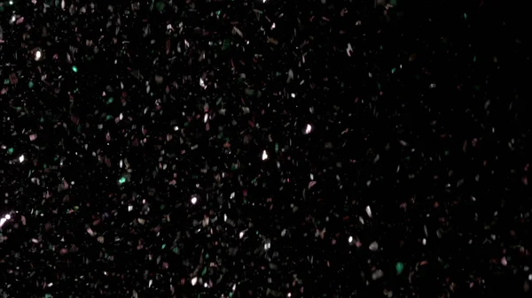Siyah arka plan üzerinde patlayan gerçekçi Glitter. — Stok fotoğraf