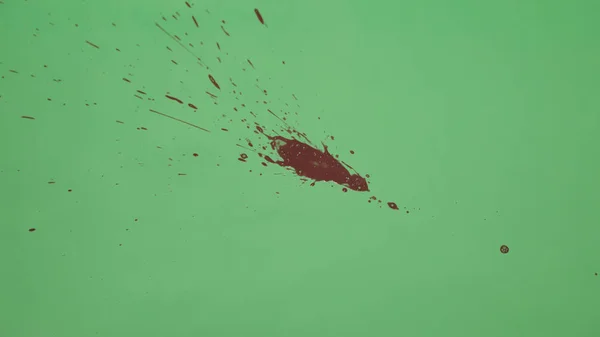 Red Ink Splatter Over Green Screen Background — Stock Photo, Image