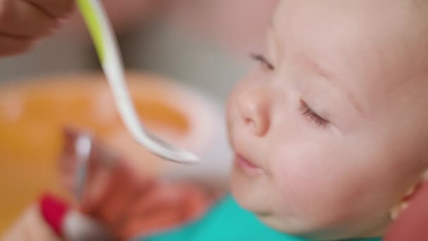 Een meisje van de Baby eten Puree thuis — Stockvideo