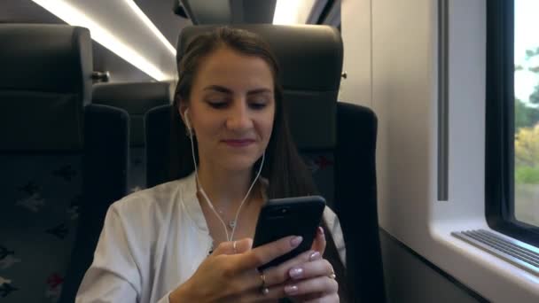 電車の中でスマート フォンを使って若い女性. — ストック動画