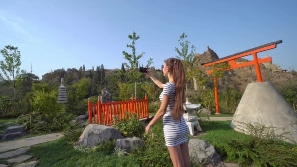 A Young Lady Taking Photos Outside — Stock Video