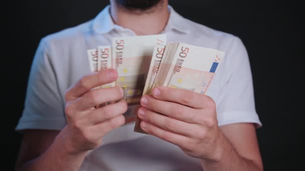 Un homme en T-shirt blanc tenant de l'argent — Video