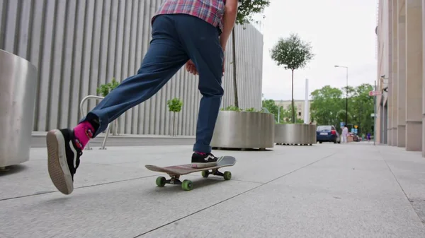 Readhead Hipster in Hat on a Skateboard