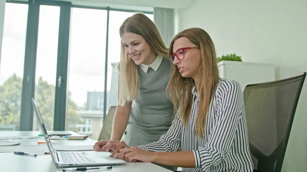 stock image Two Woman Discussing Ideas Using Laptop