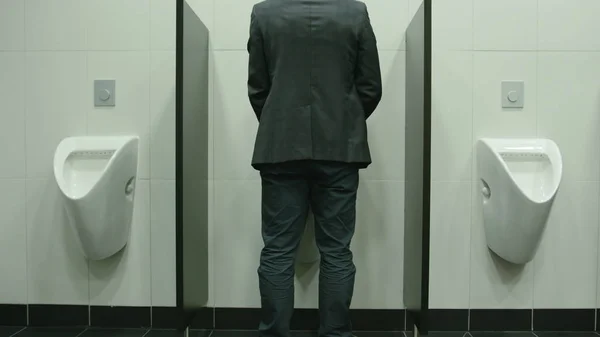 Man Peeing to Urinal in the Restroom — Stock Photo, Image