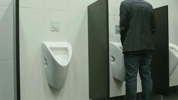 Man Peeing to Urinal in the Restroom — Stock Photo, Image