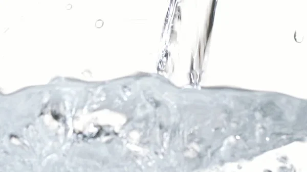 Water Pouring Macro Footage. White Background