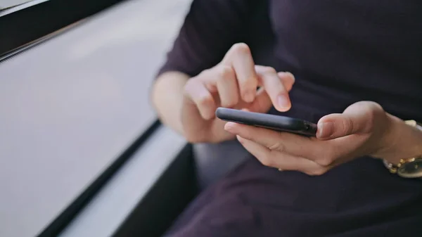 En ung dam som använder en smartphone på bussen — Stockfoto