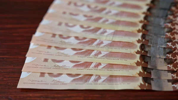 Fanned Pile of Hundred Dollar Banknotes on a Table — Stock Photo, Image