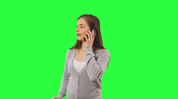 Woman isolated on green screen with phone — Stock Photo, Image