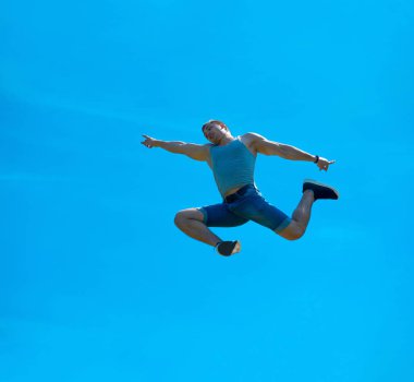 Zıplayan adam kadar. Arka plan mavi gökyüzü.