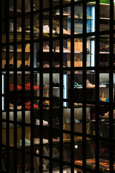 Loja de sapatos para jovens. Sapatos são colocados nas prateleiras atrás de uma grande janela — Fotografia de Stock