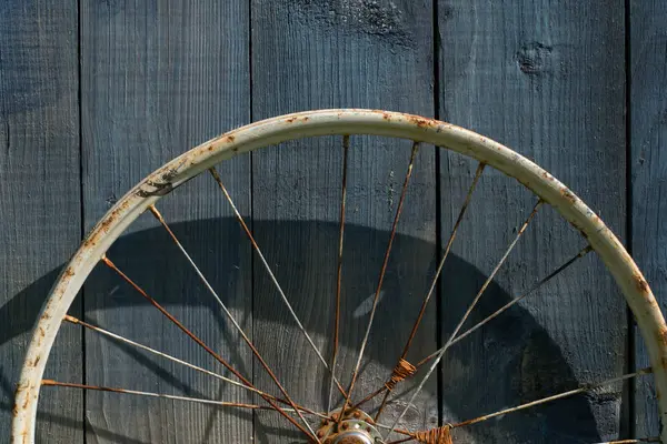 Old wheel from a bicycle on a wooden background — Stock Photo, Image