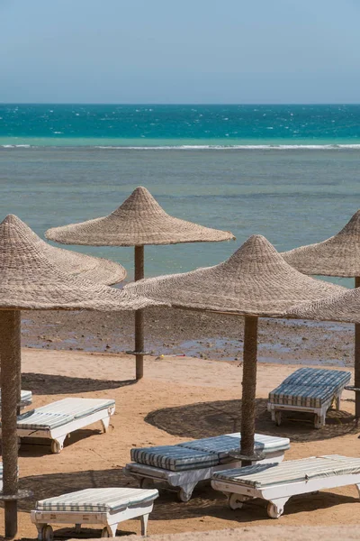 Une vue sur la mer rouge en Egypte avec des sommets en osier à partir de parasols au premier plan — Photo