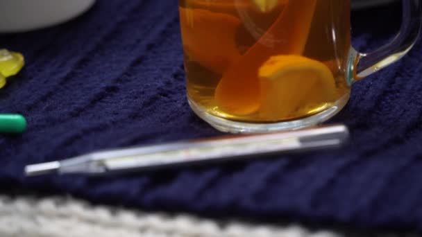 Still life of tea with lemon, tablets and thermometer, jam and berries. The concept of treating colds. — Stock Video