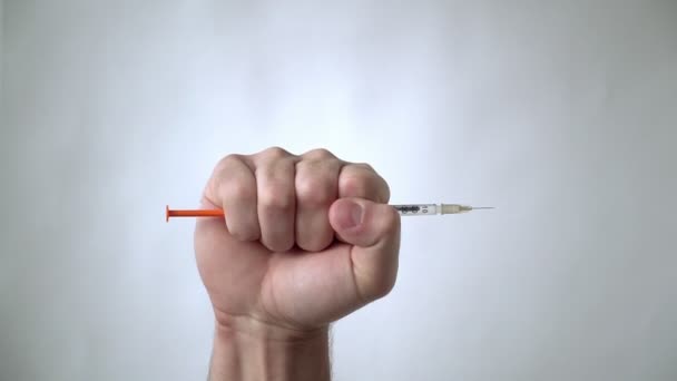 The man's hand holds, and then throws out the syringe. Victory over a disease or drug addiction. — Stock Video