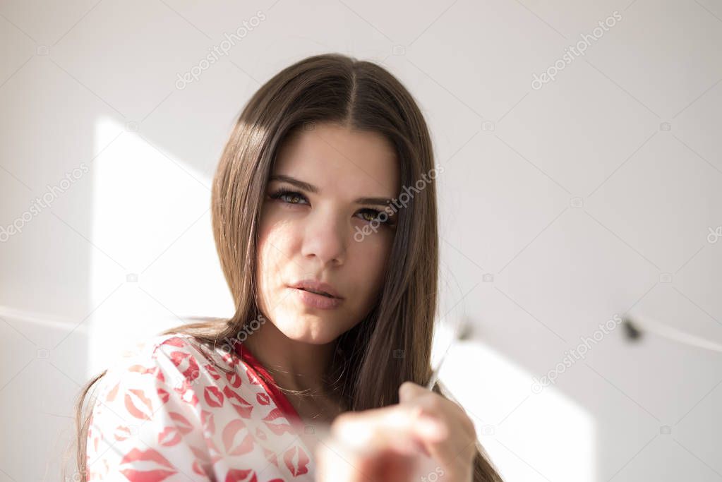 Portrait of beautiful female model looking over a shoulder on white background