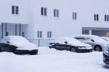 Snow on cars after snowfall. Winter urban scene clipart