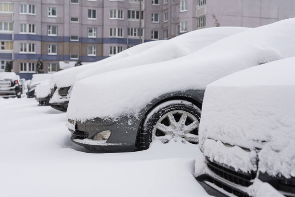 Snow on cars after snowfall. Winter urban scene
