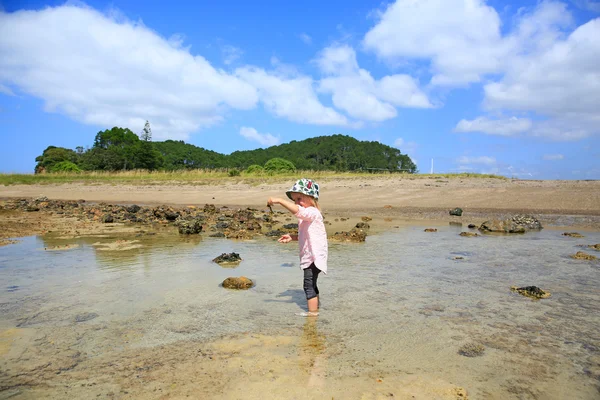 Little girl with her feet in the water. Russell Long Beach, Bay of islands. NZ — Stock Photo, Image