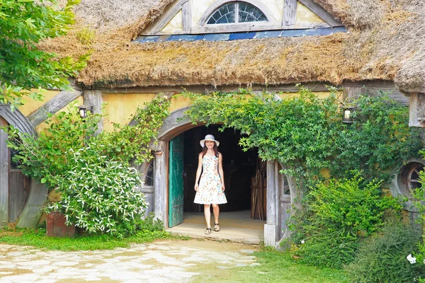 Smiling pretty woman tourist enjoying magic atmosphere in Hobbit