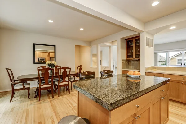 Kitchen and dining room interior with hardwood floor.