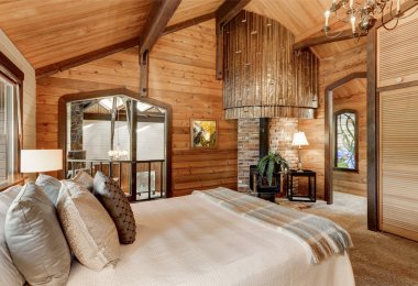 Wooden bedroom interior with high vaulted ceiling