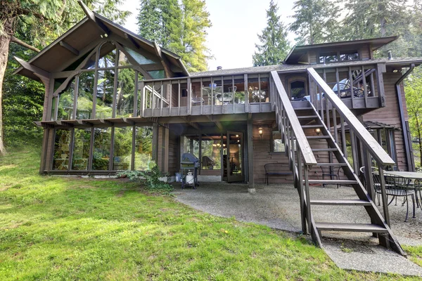 Modern countryside wooden house with big mirrored windows. — Stock Photo, Image