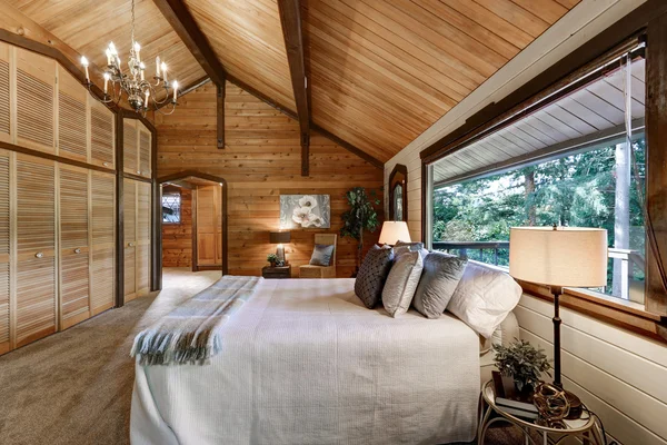 Wooden bedroom interior with high vaulted ceiling Stock Photo