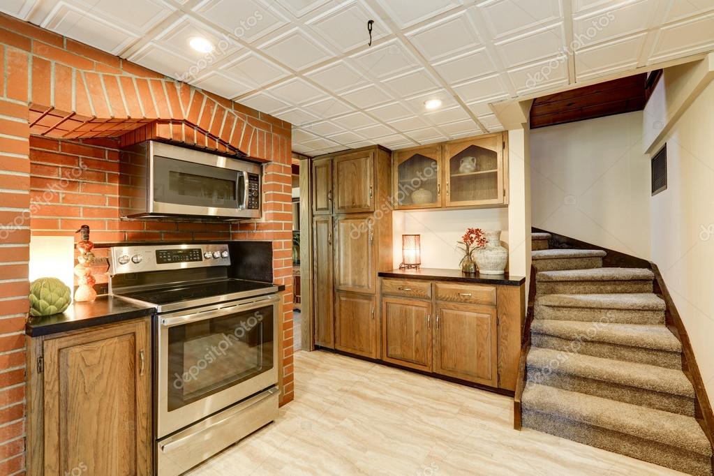 Kitchen Area With Red Brick Wall And Built In Appliances Stock