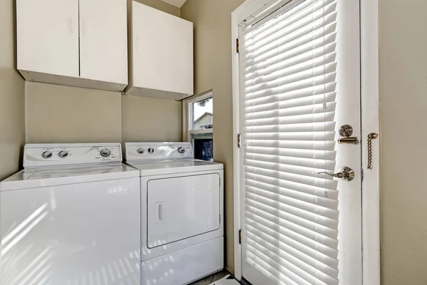 Small and simple laundry room with old-fashioned appliances — ストック写真