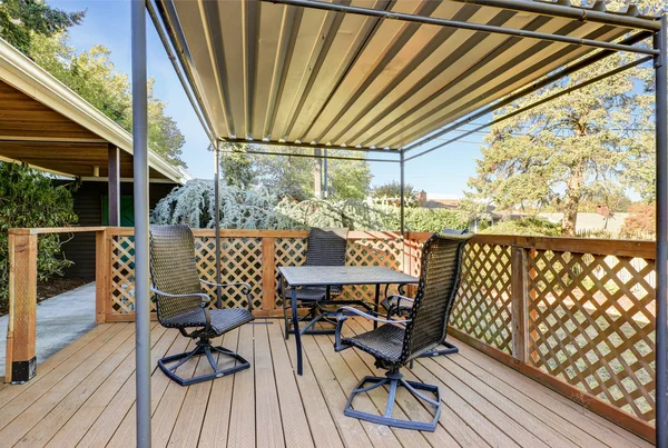 Covered wooden deck with patio table set