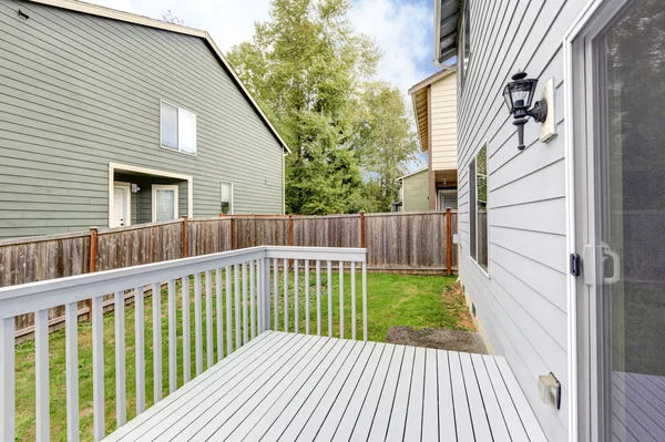 Lege houten achtertuin terras met uitzicht op naburige huizen. — Stockfoto