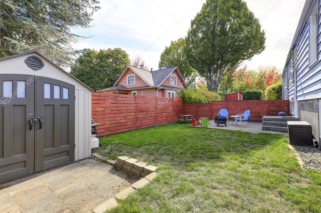 Fenced back yard with patio area and barbecue grill