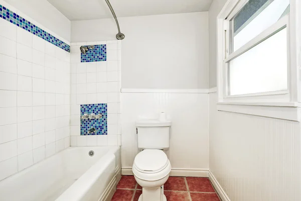 White interior of bathroom with mosaic blue tile wall trim. — Stockfoto