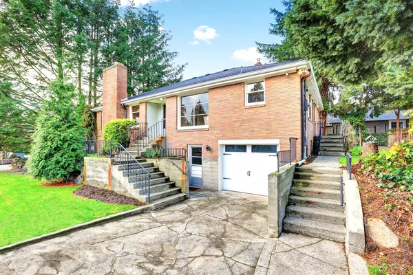 American red brick two story house exterior with garage