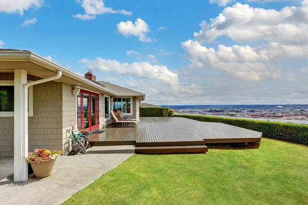 Luxury house exterior with large wooden walkout deck — Stock Photo, Image