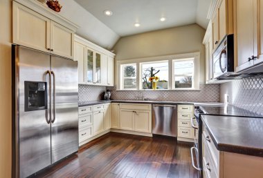 Soft beige kitchen cabinets in a kitchen room clipart