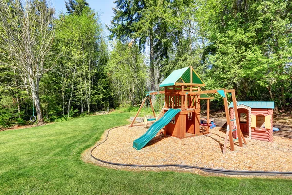 Kids playground in the backyard of a house — Stock Photo, Image