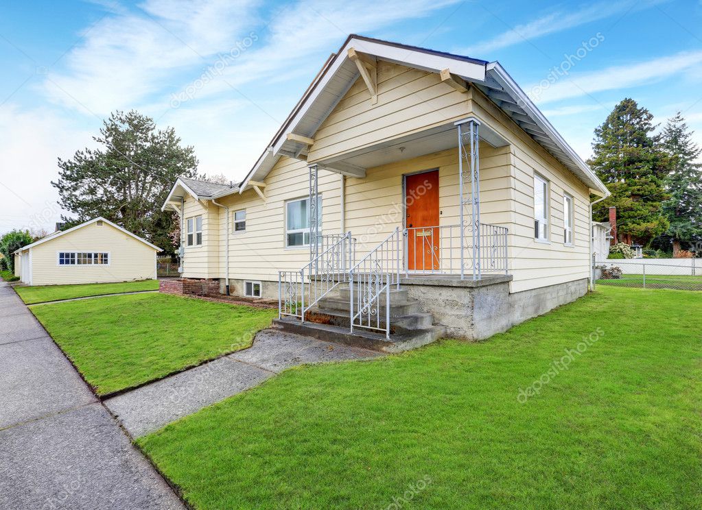 Casa color beige | Exterior de la pequeña casa color beige en un día
