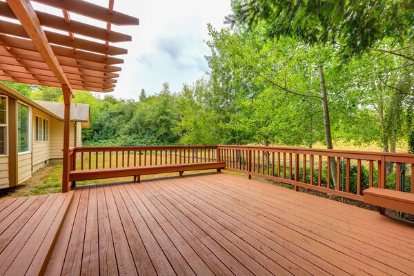 Exterior of horse ranch with large wooden walkout deck
