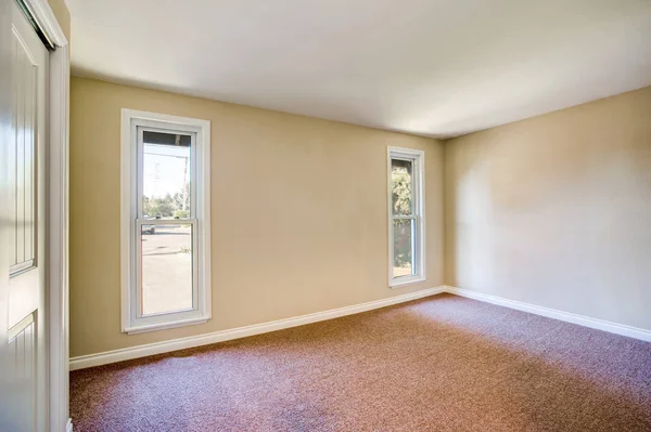 Empty room interior with brown carpet and light beige walls — Stock Photo, Image