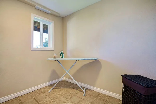 Beige empty room interior with ironing board — Stock Photo, Image