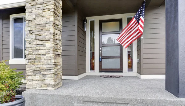 Column porch of luxurious house with American flag