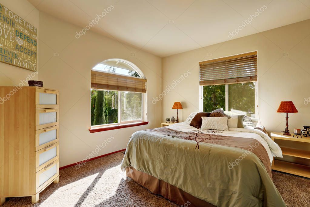 Bright sunny bedroom interior with modern cabinet and arched
