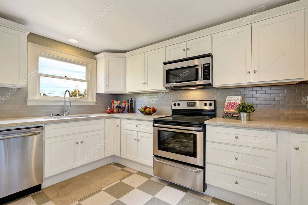 A Small Appliance Microwave In A Green Kitchen With Cream Colored Cabinets  In A New Construction Home With Granite Countertops And Lots Of Cabinets  And Storage Space Stock Photo - Download Image