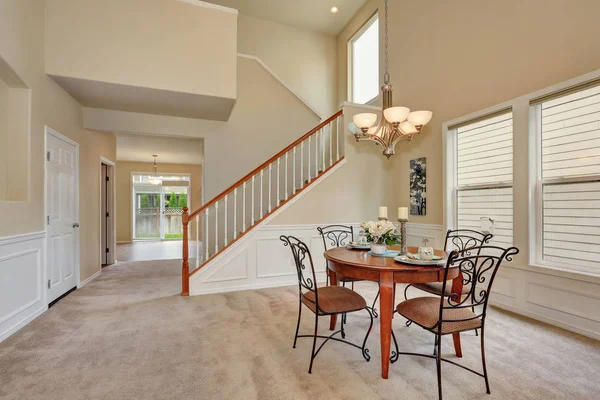 Sala da pranzo beige interno con soffitto alto e scala — Foto Stock