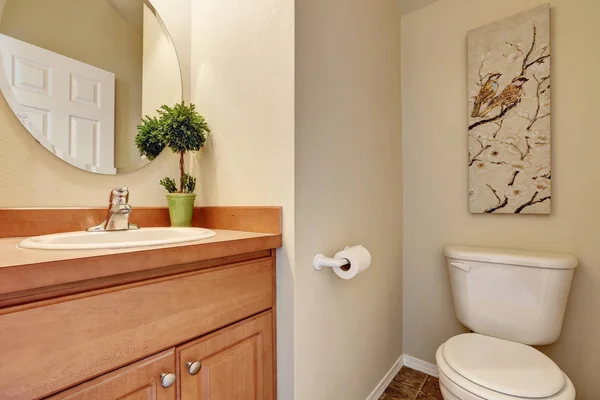 Half bathroom interior with a toilet and small vanity cabinet. — Stock Photo, Image