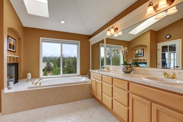 Luxury bathroom interior. Orange brown walls and vaulted ceiling